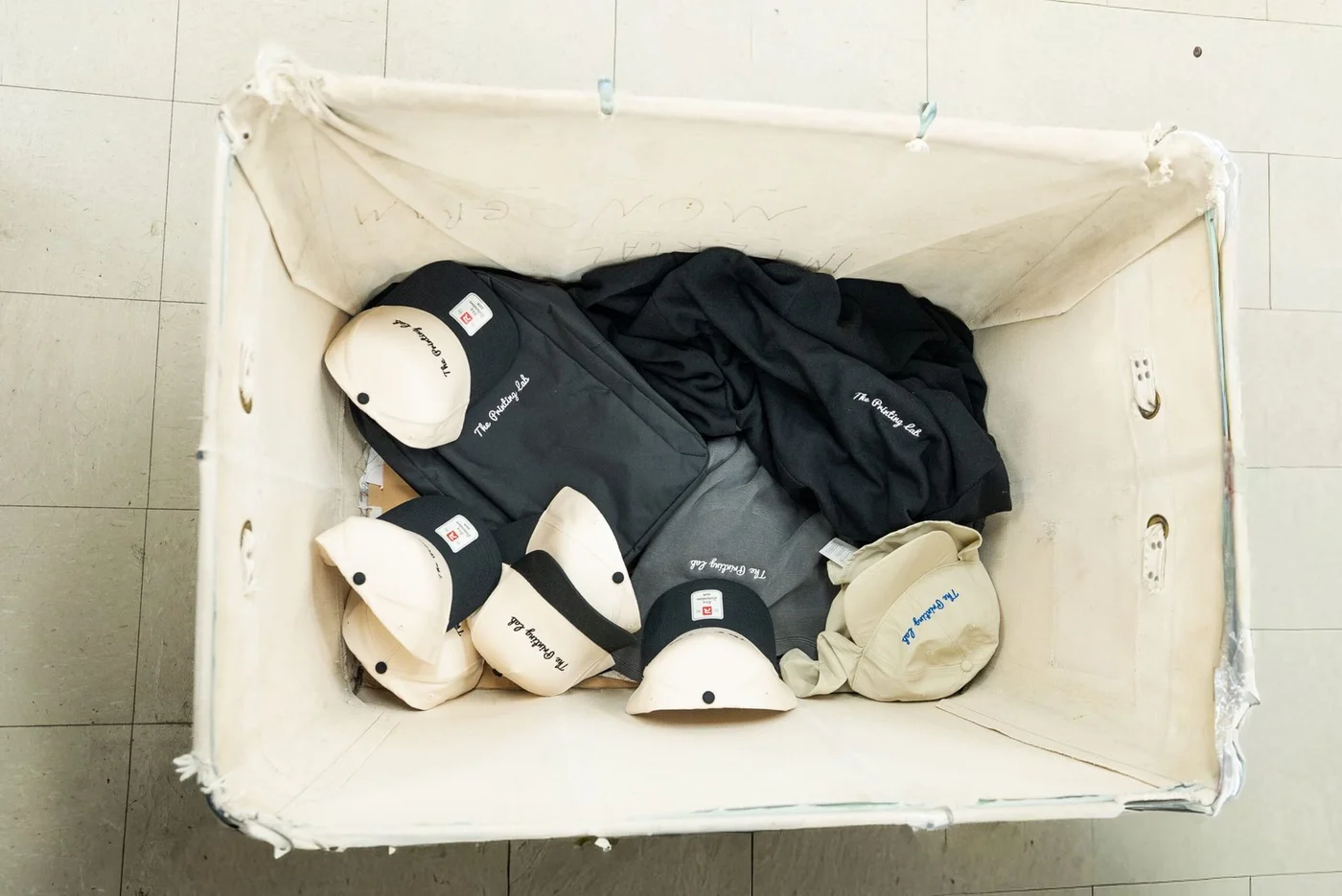 The Printing Lab embroidered caps and apparel in a canvas cart